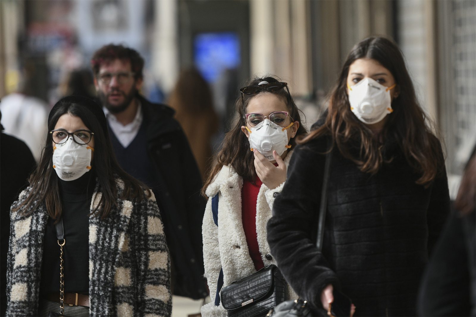 Women wearing facemasks while walking outdoors Milan Italy February 2020 coronavirus COVID 19
