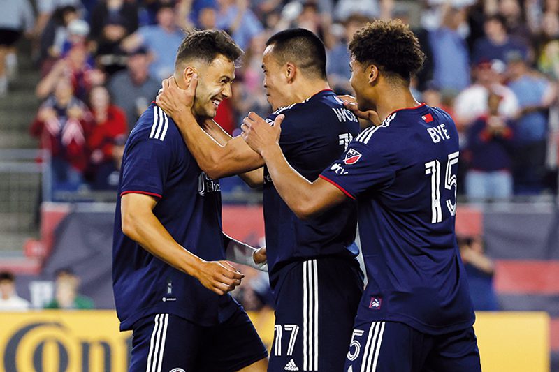 Jun 24, 2023; Foxborough, Massachusetts, USA; New England Revolution forward Bobby Wood (17) and midfielder Brandon Bye (15) move in to congratulate forward Giacomo Vrioni (9) after he scored against the Toronto FC during the second half at Gillette Stadium. Mandatory Credit: Winslow Townson-USA TODAY Sports