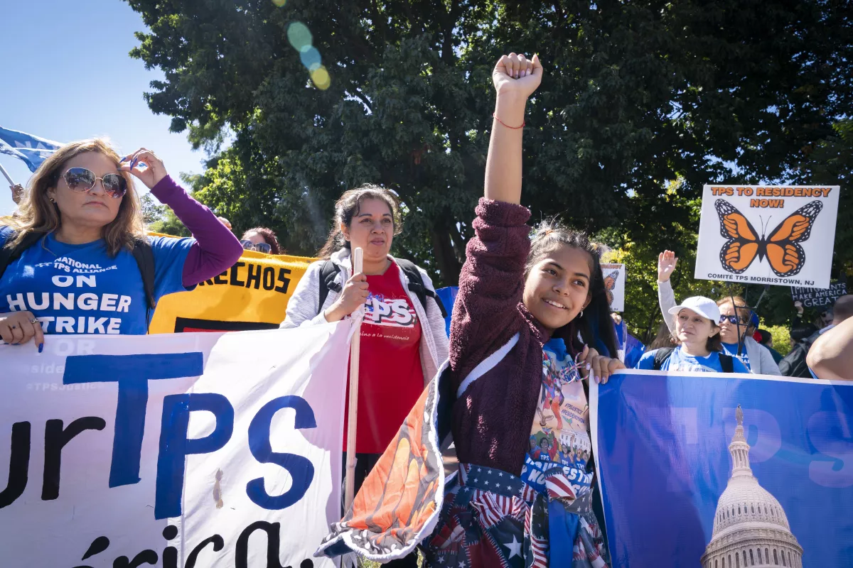 Marilyn Miranda, 12, of Washington raises her hand up during a demonstration for an extension of the Temporary Protected Status program on Sept. 23, 2022, at Lafayette Park near the White House. (Jacquelyn Martin / Associated Press)