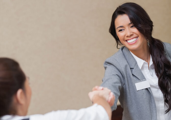 Businesswomen shaking hands in meeting