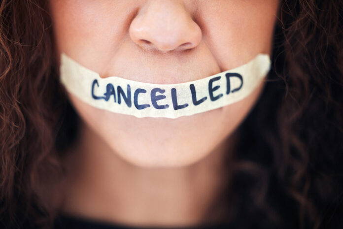 person with tape across their mouth saying cancelled