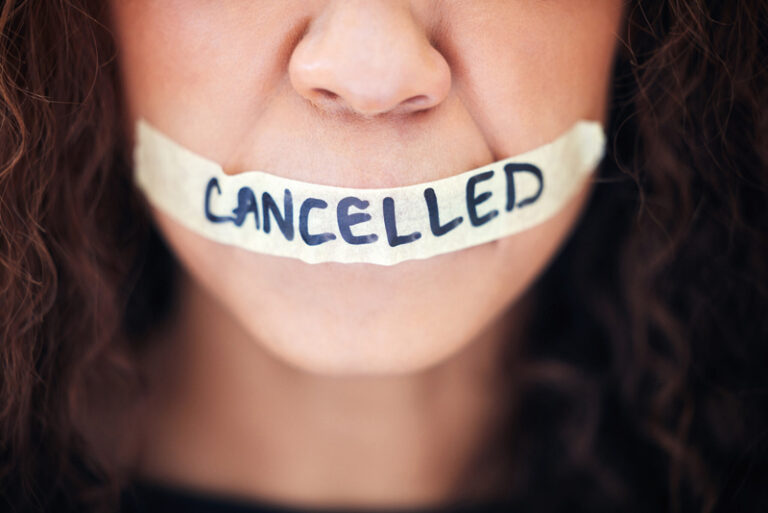 person with tape across their mouth saying cancelled