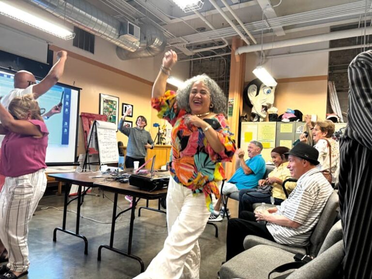 Stony Brook resident Maria Patrone responds joyously to a judge’s decision to consider removing the co-op’s board president, who has been accused of gross mismanagement of the development.