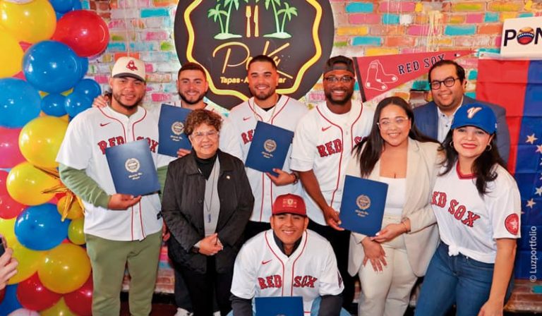 En medio de los peloteros de los Red Sox, Gladys Oliveros y Alexandra Valdez de la alcaldía de Boston, Katiuska Valiente y Ciro Valiente.