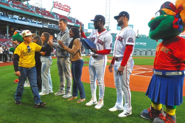 El Mundo Boston and the Red Sox honored Latino middle school students from East Boston and Chelsea during the 1st of three Latino Youth Recognition Days this year. In the photo: Student Damian Garcia is congratulated by State Senator Lydia Edwards and Red Sox Players Andruw Monasterio and Isiah Kiner-Felefa.