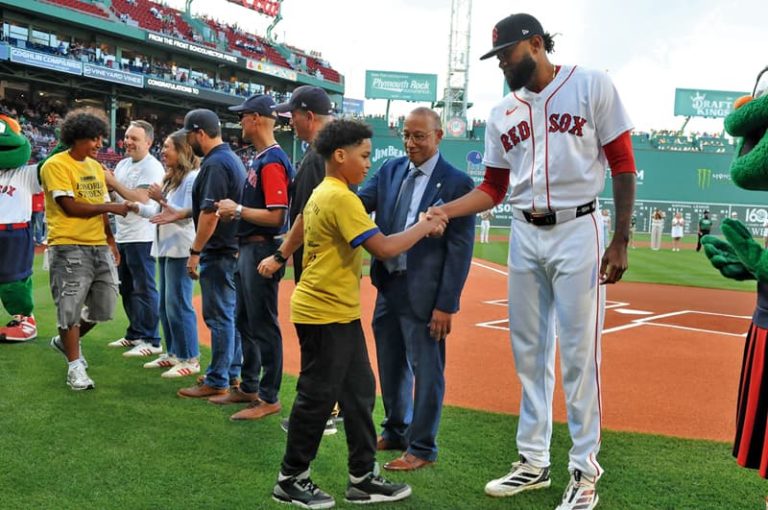 El Mundo Boston and the Red Sox honored Latino middle school students from Lawrence Public Schools during the 2nd of three Latino Youth Recognition Days this year. In the photo: Student William T. Felix of SES School in Lawrence is congratulated by Red Sox Player Tyron Guerrero.